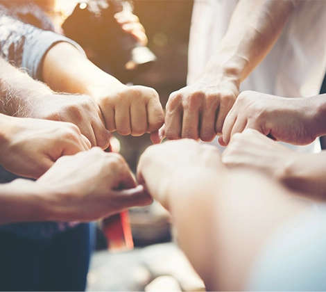 students joining hands together